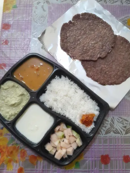 A wholesome South Indian meal featuring two Ragi Rottis (finger millet bread), coconut chutney, steamed rice, sprouts sambar, fresh curd, pickle, and cut fruits.