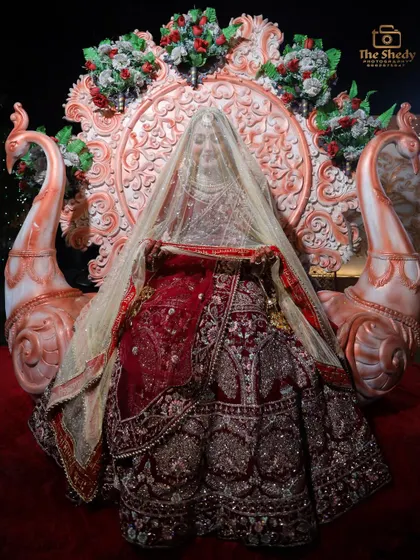 A mysterious and elegant shot of the bride completely covered by her veil while seated on a grand throne. This photo is pure art.