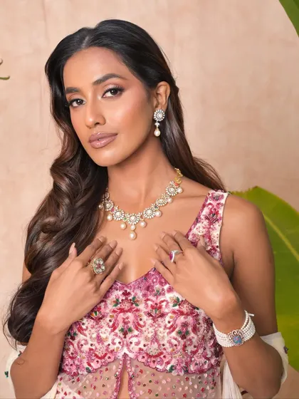 A festive look that feels light yet luxe. This makeup on a dusky beauty features a glowing base, understated glam on the eyes, and radiant highlights.