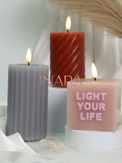 A close-up of our new message and pillar candles. The "Light Your Life" candle is a perfect motivational gift, while the textured spiral and ribbed designs add a touch of modern elegance.