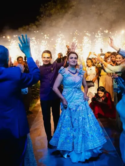 The couple makes a grand entrance, surrounded by guests and a shower of cold pyrotechnics. We love creating these high-impact moments that kick off the party with incredible energy.