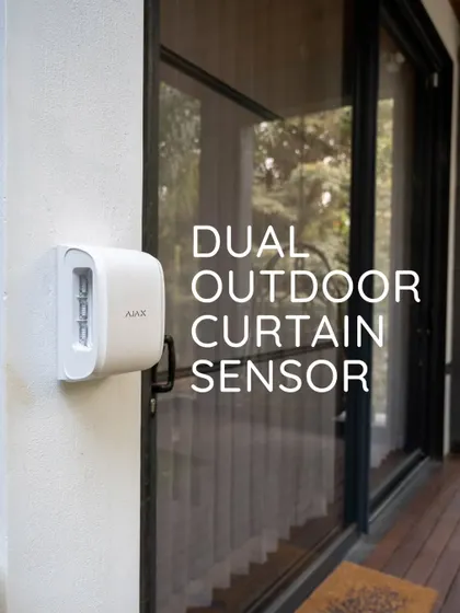 This is an Ajax dual outdoor curtain sensor installed on a home's exterior. It's a powerful tool for creating a secure perimeter, detecting motion along walls and windows before an intruder can get close.