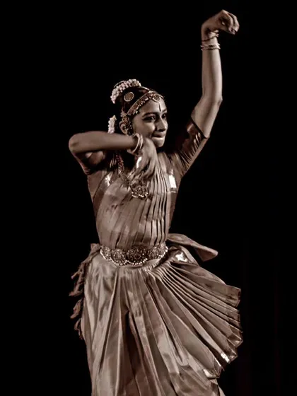 A sepia-toned photograph of Ramya Suresh, giving a timeless quality to her classical form.