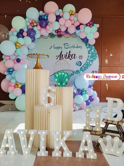 Another magical mermaid theme for Avika's sixth birthday, with marquee letters, a custom backdrop, and a beautiful pastel balloon arrangement.