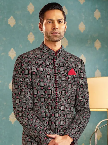 Bold patterns meet timeless charm in this statement bandhgala. We designed this piece with intricate geometric patterns and a sharp red trim to redefine regal elegance for the modern man.