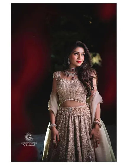Mahima posing for a dramatic shot at her engagement. Her makeup is bold and defined, ensuring her features are beautifully captured even in more artistic and moody lighting.