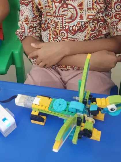 A close-up of a robotic dragonfly, showcasing the intricate design and combination of mechanical parts and sensors.