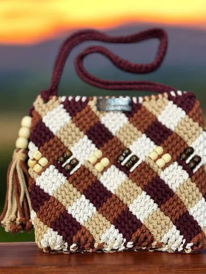 A beautiful multi-tonal sling bag with wooden beads, perfect for an outdoor wedding or festive event.