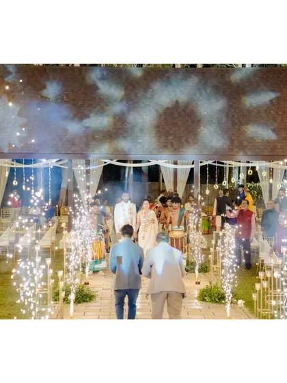 A grand entrance for the couple at the Sangeet, with cold pyrotechnics lighting up the path.