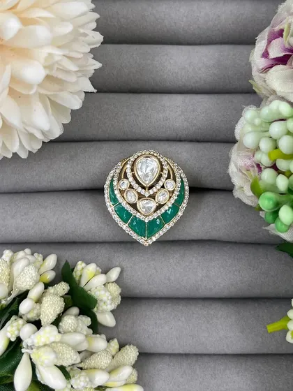 Our leaf-shaped adjustable rings, featuring a large central Moissanite stone surrounded by American Diamonds. These are available in green, red, and pink Meenakari finishes.
