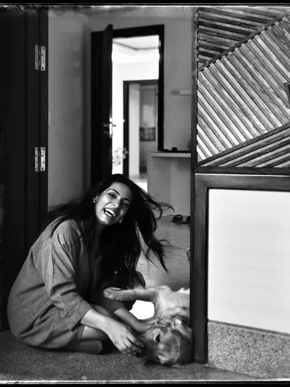 Shivika, sharing a playful moment with her dog on the floor. The low angle and her laughter make this feel incredibly intimate and real.