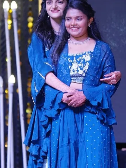 A tender moment between sisters on stage. Our choreography often includes moments that highlight the special relationships within the family, making the performance more meaningful.