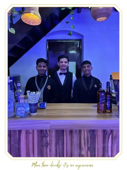 Three of our professional bartenders smiling and ready to serve, representing the friendly and welcoming service we provide.