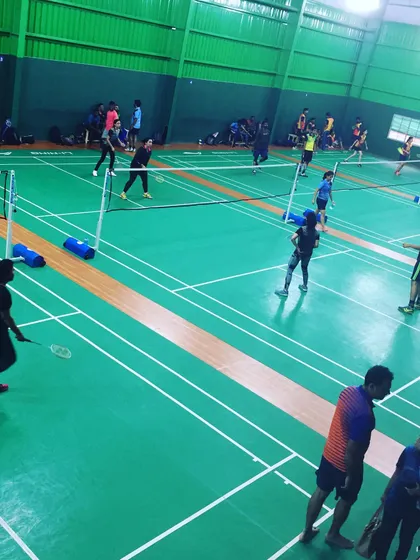 Teammates strategize during a doubles game. These are the moments of collaboration and fun that make a corporate sports event a successful team-building activity.