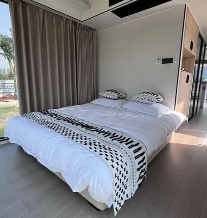This is the bedroom setup in our Space Capsule E8 model. It features a clean, minimalist design with large windows to make the most of scenic views, perfect for hospitality projects.
