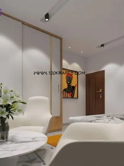 The bedroom from our 'Modern Ethnic' project. The space is clean and contemporary, with a small seating area and subtle ethnic art adding a touch of cultural flair.