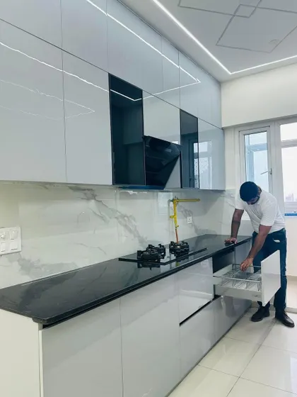 Demonstrating the functionality of a cutlery drawer in a new modular kitchen. Every detail is planned for convenience, from soft-close drawers to organized compartments.