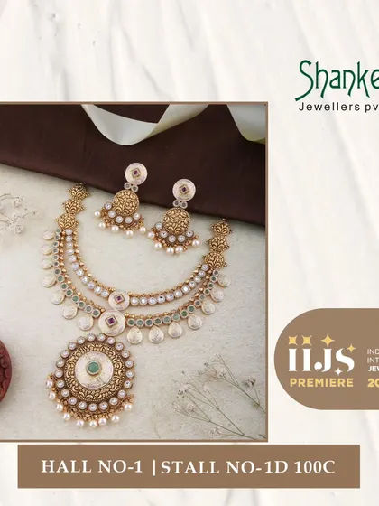 A touch of vintage grace is evident in this layered necklace set. The design uses coin-like elements and a central Kundan pendant, creating a beautiful fusion of styles.