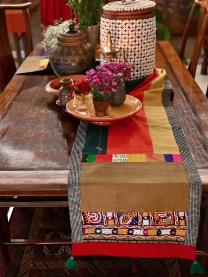 The autumnal runner styled on a dining table with earthy pottery, showing how it can set the mood for a seasonal tablescape.
