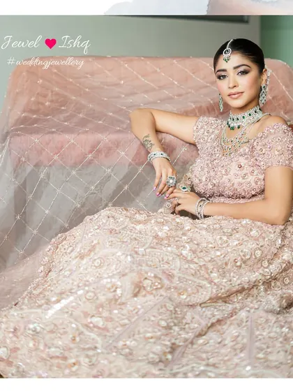 The full picture of bridal perfection. This look, combining a soft pink lehenga with the striking green of emeralds, is a testament to modern bridal glamour.