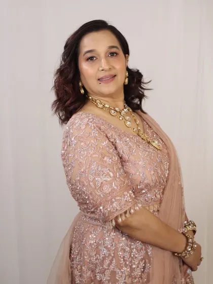 A graceful and elegant look for the mother of the bride, featuring soft makeup that enhances her features without being overpowering.