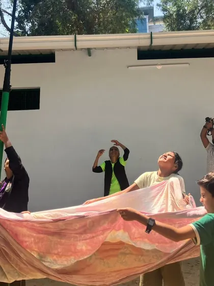 In a powerful simulation, children practice how to rescue a bird entangled in manja kite string. This activity highlights a real-world local danger and empowers them with the knowledge to help.