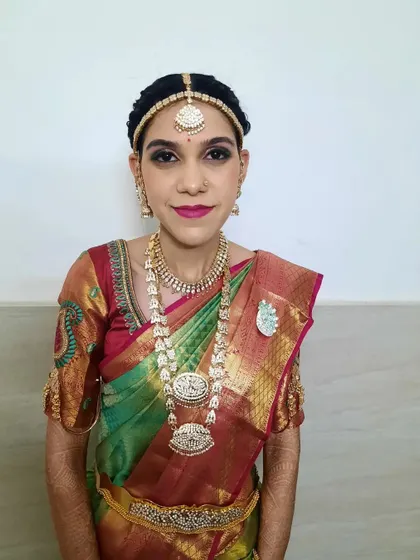 A full-length view of the bride's Varapooja look. The makeup is designed to be picture-perfect from every angle, ensuring she looks radiant throughout the ceremony.