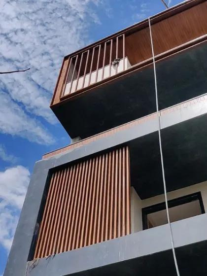 Another view of the apartment building facade, focusing on the interplay between the solid balcony and the vertical wooden slats below. This detail shows our use of material and texture to add rhythm and warmth to the building's exterior.