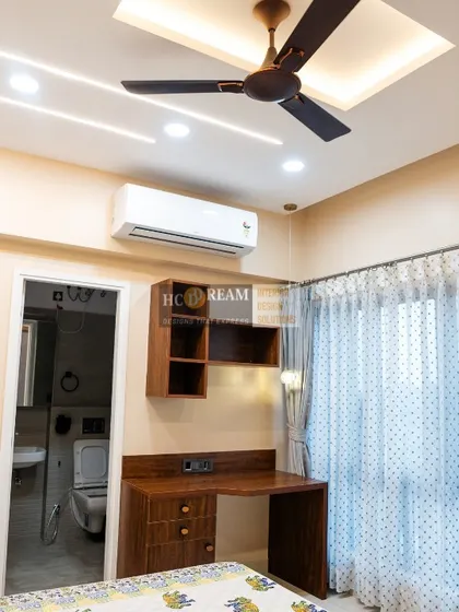 Another view of the bedroom with the integrated study desk, showing the view into the attached bathroom. The layout is planned for maximum convenience and efficient use of space.