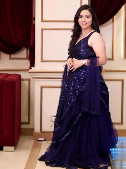 The full look, showcasing her beautiful ruffled gown. The makeup and hair are designed to complement the elegance of her outfit.