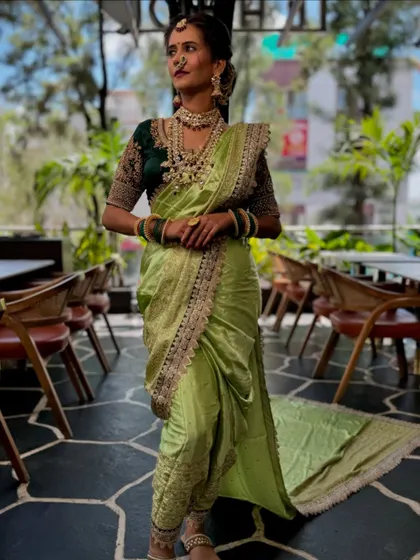 The full look of the light green Nauvari, with its long, flowing pallu. This drape is both traditional and incredibly stylish.