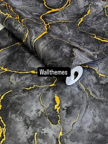A dramatic black marble-effect wallpaper with striking gold veins running through it.