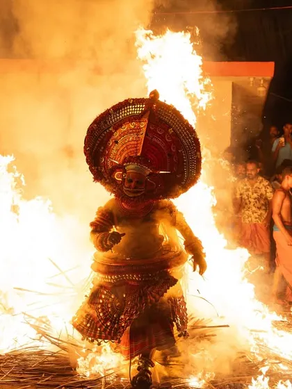 A sequence documenting the Kandanar Kelan Theyyam's fearless dance through fire. These images show the performer's complete surrender to the flames, a testament to the ritual's power.