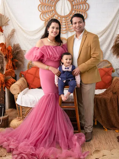 A complete family portrait in our autumn boho setup. The family's coordinated outfits look perfect against the rich, warm colors of the theme.