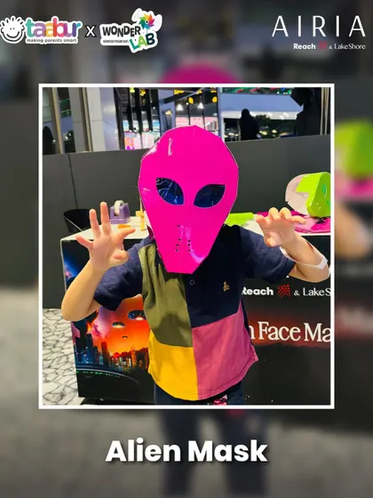 Kids making their own alien masks to wear at the Alien World event.