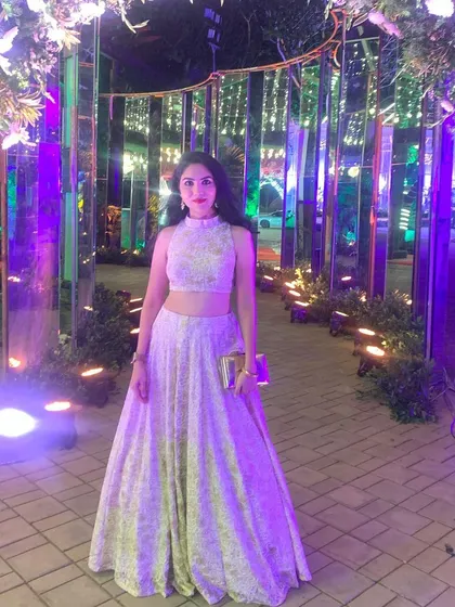 This client looks ethereal in a custom white chikankari lehenga set, perfect for a reception or evening event. The high-neck embroidered crop top and full skirt create a sophisticated and elegant silhouette.