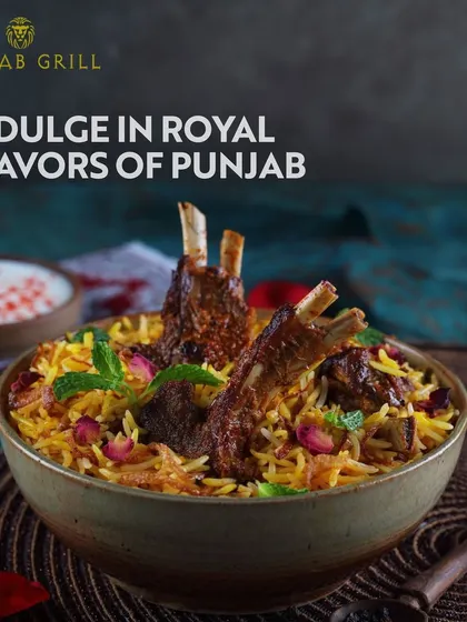 Indulge in the royal flavours of Punjab with this magnificent lamb biryani from Punjab Grill. The dish, garnished with mint and rose petals, represents the rich and aromatic offerings of North Indian cuisine.