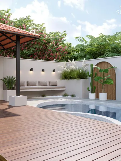 This poolside design features a raised wooden deck leading to a curved pool, complemented by a built-in seating area and a tiled-roof gazebo. We used a mix of pampas grass and cacti to add texture and create a modern, slightly rustic feel.
