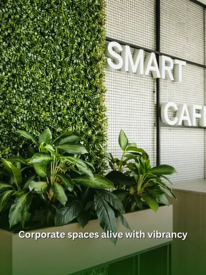 A vertical green wall paired with planters at the base makes this 'Smart Cafe' come alive. This combination of textures and plant types adds vibrancy and makes the space more inviting for employees.