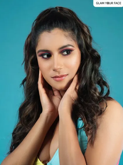 A vibrant, colorful eye makeup look against a bright blue background. This is a great example of an editorial makeup style that is playful and bold.