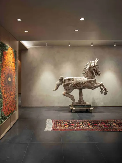 An antique wooden horse from Kutch, sourced for its rustic charm and historical significance, stands as a powerful statement piece in the basement lobby. It grounds the space with a sense of history and narrative.