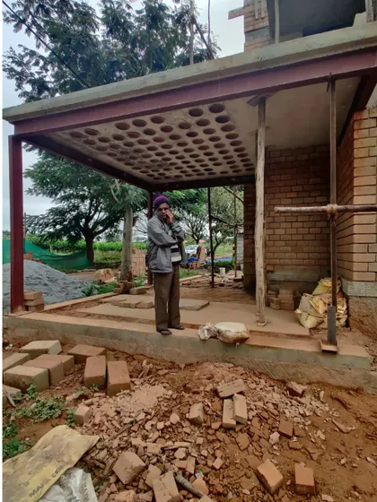 The porch area during construction, highlighting the use of steel beams to support the innovative filler slab roof.