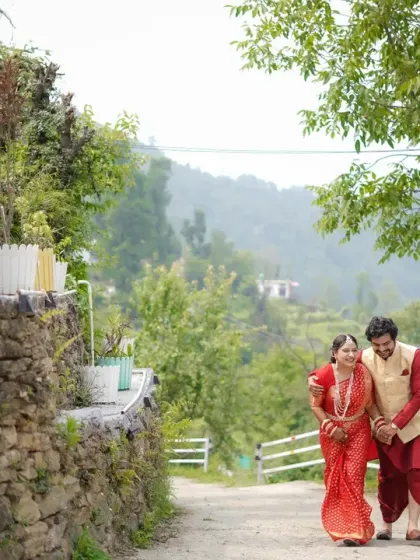 A leisurely stroll along a rustic path. This full-length shot captures the couple's relaxed happiness and the beautiful scenery of their wedding location.