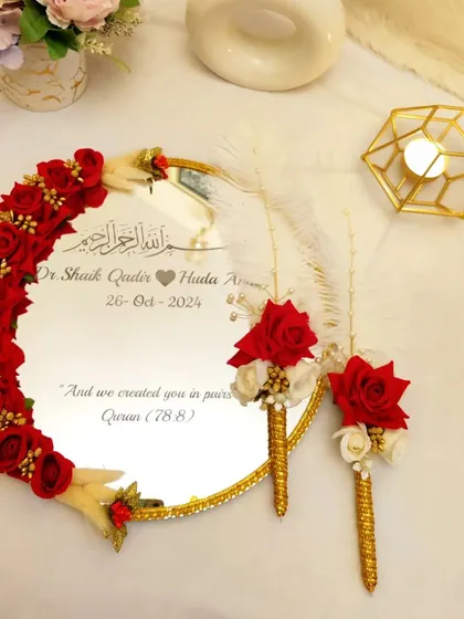 For your most sacred "Qubool Hai" moment. I designed this personalized 'Muah Dekhaye' mirror with deep red roses and delicate feathers. The couple's names and wedding date are inscribed, along with a verse from the Quran, making it a cherished keepsake of your Nikah.