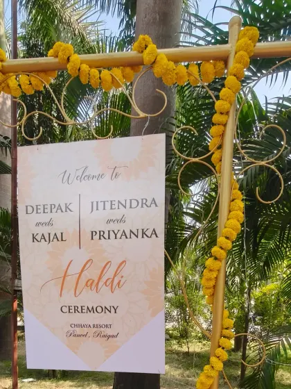 A personalized welcome sign for a Haldi ceremony, decorated with marigold flowers. It's a small detail that makes guests feel welcomed and adds a personal touch to the event.