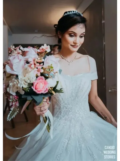 A close-up of the bride holding her beautiful bouquet, her expression serene and happy.