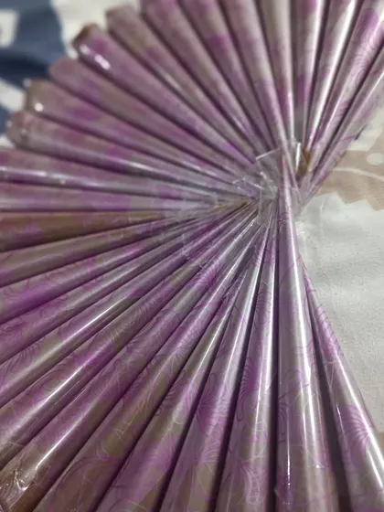 A fan of freshly made henna cones with beautiful purple wrappers. They are sealed and ready to be shipped out for you to enjoy.