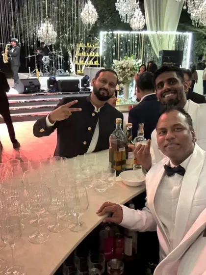 A great photo of our team with a happy guest at a wedding reception. Our goal is to make every guest's experience special.
