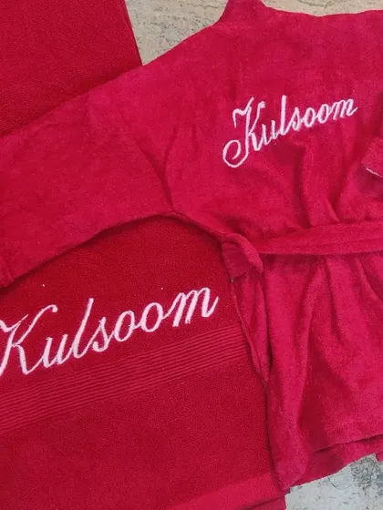A matching set for a toddler is always a great idea. This vibrant red bathrobe and bath towel are both customized with her name, 'Kulsoom', in a lovely white script.