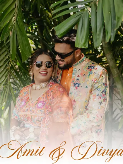 A soft, dreamy portrait of the couple surrounded by palm leaves. The hazy effect adds a romantic touch to this beautiful Haldi carnival photo.